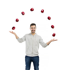 Image showing Happy man juggling with apples 