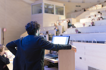 Image showing Speaker giving talk on podium at Business Conference.