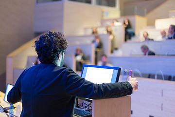 Image showing Speaker giving talk on podium at Business Conference.