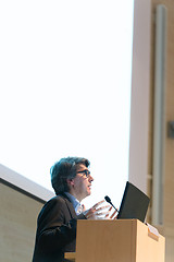 Image showing Speaker giving talk on podium at Business Conference.