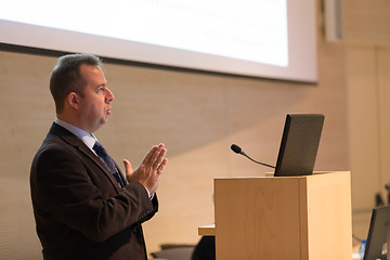 Image showing Speaker giving talk on podium at Business Conference.