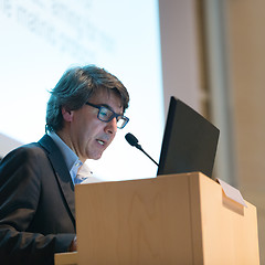 Image showing Speaker giving talk on podium at Business Conference.