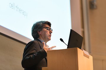 Image showing Speaker giving talk on podium at Business Conference.