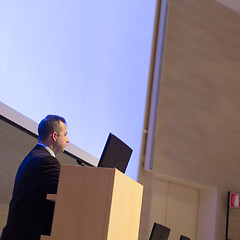 Image showing Speaker giving talk on podium at Business Conference.