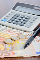 Image showing Calculator and money on the table
