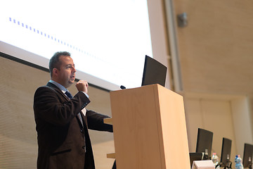 Image showing Speaker giving talk on podium at Business Conference.