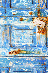Image showing blue stripped paint in   rusty nail