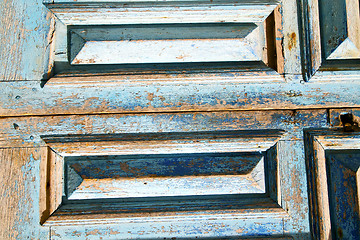 Image showing dirty  paint   the blue  door  rusty nail