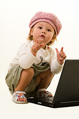 Image showing Adorable baby with laptop