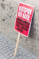 Image showing Protest sign placard anti-NATO rally demonstration against NATO 