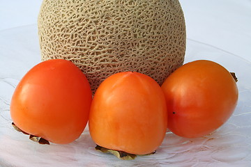 Image showing Cantaloupe melon and persimmon