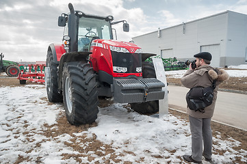 Image showing Photographer shoots tractor on exhibition