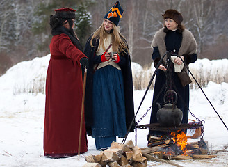 Image showing Three women near the fire