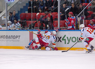 Image showing E. Sallinen (76) and A. Stas (23) fall down