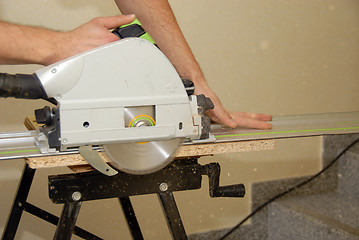 Image showing Carpenter and saw