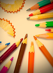 Image showing several colored pencils and shavings on white background