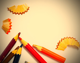 Image showing several aged pencils and shavings on white background