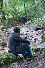 Image showing Eldery man sitting in forest