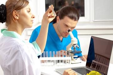 Image showing Doctor examines a test tube