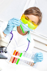 Image showing woman doctor looking at a test tube