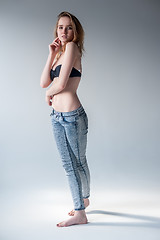 Image showing Attractive smiling woman in jeans and bra