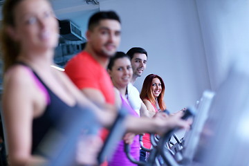 Image showing Group of people running on treadmills