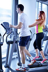 Image showing Group of people running on treadmills