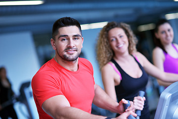 Image showing Group of people running on treadmills