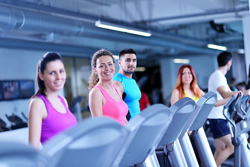 Image showing Group of people running on treadmills