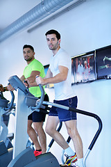 Image showing Group of people running on treadmills