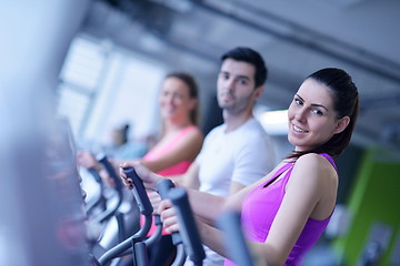 Image showing Group of people running on treadmills