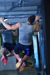 Image showing handsome man exercising at the gym