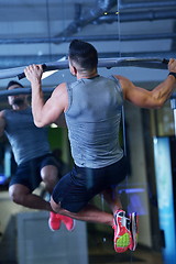 Image showing handsome man exercising at the gym