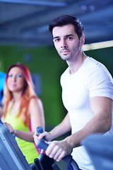 Image showing Group of people running on treadmills