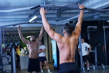 Image showing handsome man exercising at the gym