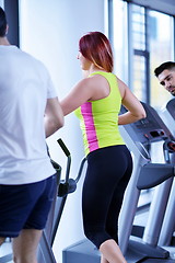 Image showing Group of people running on treadmills