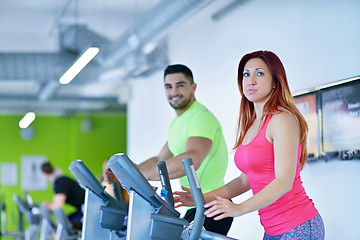 Image showing Group of people running on treadmills