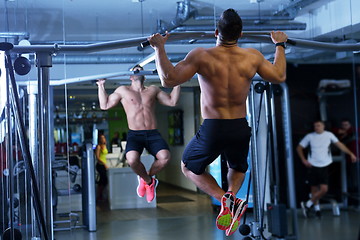 Image showing handsome man exercising at the gym