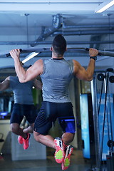 Image showing handsome man exercising at the gym