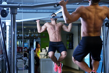 Image showing handsome man exercising at the gym