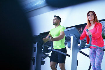 Image showing Group of people running on treadmills