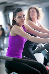 Image showing Group of people running on treadmills