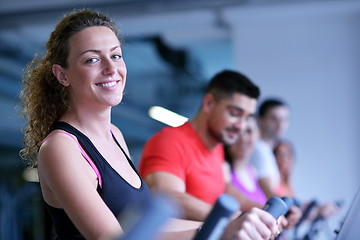 Image showing Group of people running on treadmills