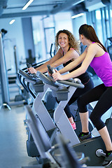 Image showing Group of people running on treadmills