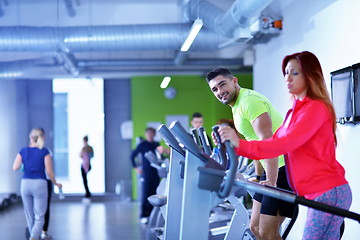 Image showing Group of people running on treadmills