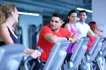 Image showing Group of people running on treadmills