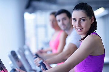 Image showing Group of people running on treadmills