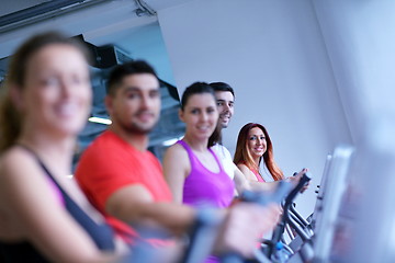 Image showing Group of people running on treadmills