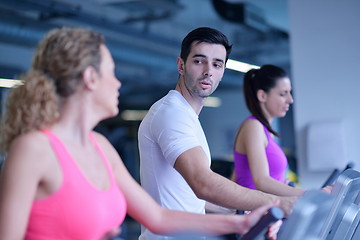 Image showing Group of people running on treadmills