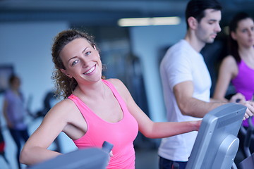 Image showing Group of people running on treadmills